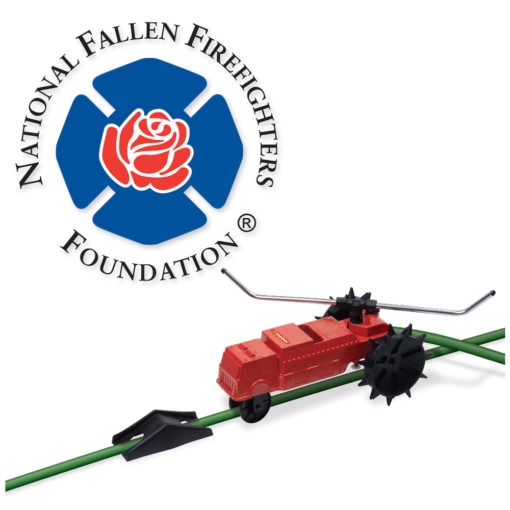 The image displays a logo for the National Fallen Firefighters Foundation, featuring a stylized rose, along with a small, red, toy fire truck on a green surface.