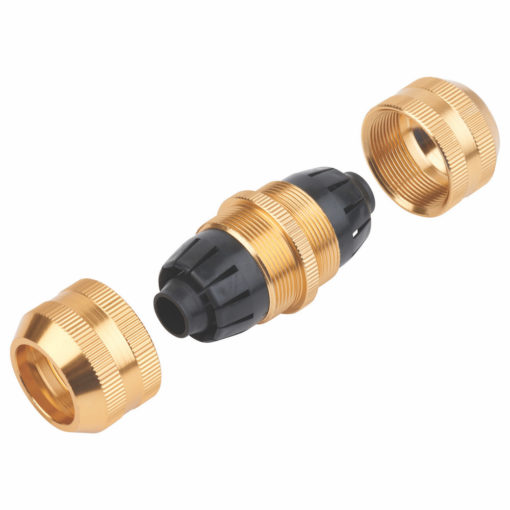 This is an image of a disassembled cable gland with its parts laid out. It includes a black rubber sealing part and golden metallic components.