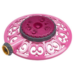 This image shows a pink and gray plastic rotating sprinkler with a decorative design, featuring a water inlet connection on its side.