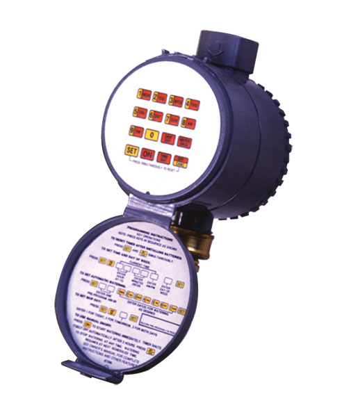 This image displays an industrial timer or controller with a clear flip-open cover revealing buttons and programming instructions. It's mounted on a dark background.