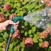 Melnor Insulated Nozzle spraying the gentle rinse pattern in front of flowers