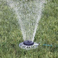 Metal 8-Pattern Sprinkler spraying water on a green grass