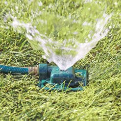 Melnor Square Spot Sprinkler spraying stream of water over green lawn