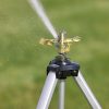 Melnor Metal Pulsating Sprinkler with Tripod spraying water over green lawn