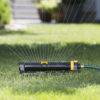 XT4200 Melnor XT 4,500 Sq. Ft. Turbo Oscillating Sprinkler with Flow Control gently spraying water over green lawn