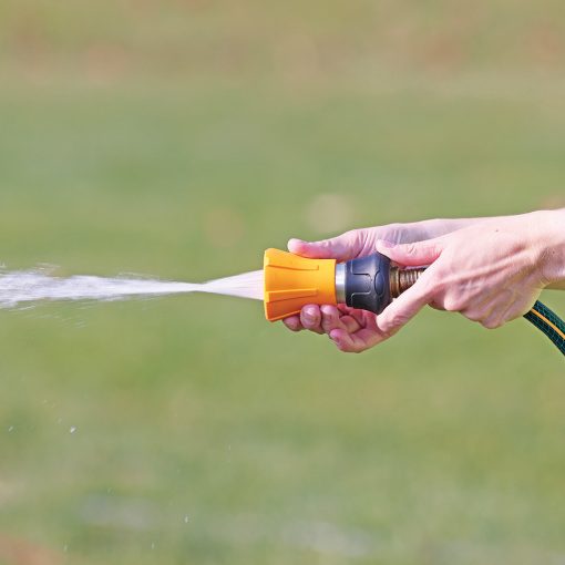 XT509 Melnor Fireman's Nozzle jet spray pattern spraying in front of green grass background