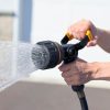 Melnor Torrent Hose Nozzle spraying water in front of garage truck