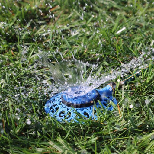 Melnor Sprout 8-Pattern Sprinkler spraying water over green lawn