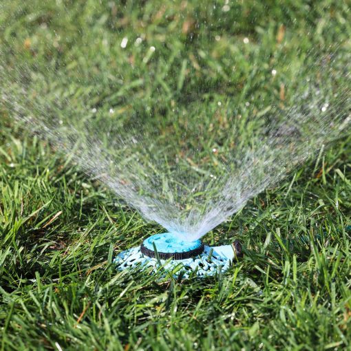 Melnor Multi-Pattern Sprout Sprinkler spraying watering pattern over green lawn