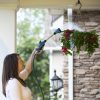 Woman watering hanging flower basket with Melnor Sprout Watering Wand