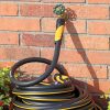 Melnor XTFusion Garden Hose connected to faucet next to brick house